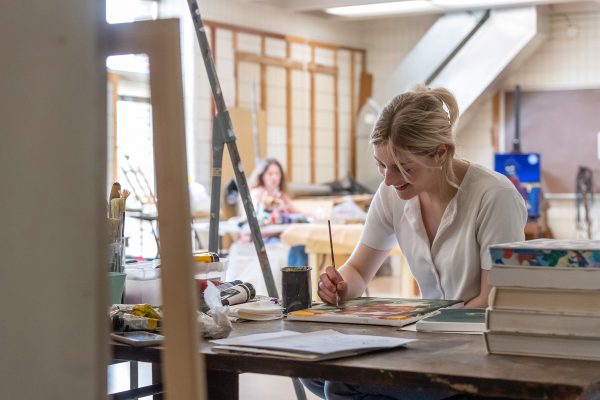 A woman painting in the Alexander Fine Arts Building