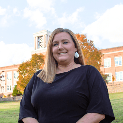 A photo of Amanda Revels standing in front of the Concord University Bell Tower