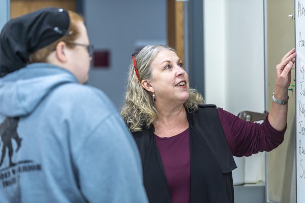 Professor Lori Pace talking to a student
