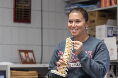 Dr. Laura Wamsley holding a model spine
