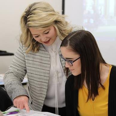 A professor helping a student on an assignment