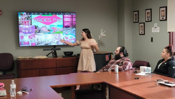 Student presenting a business plan to a panel of judges.