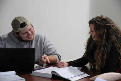 Two Business Administration students working on homework together