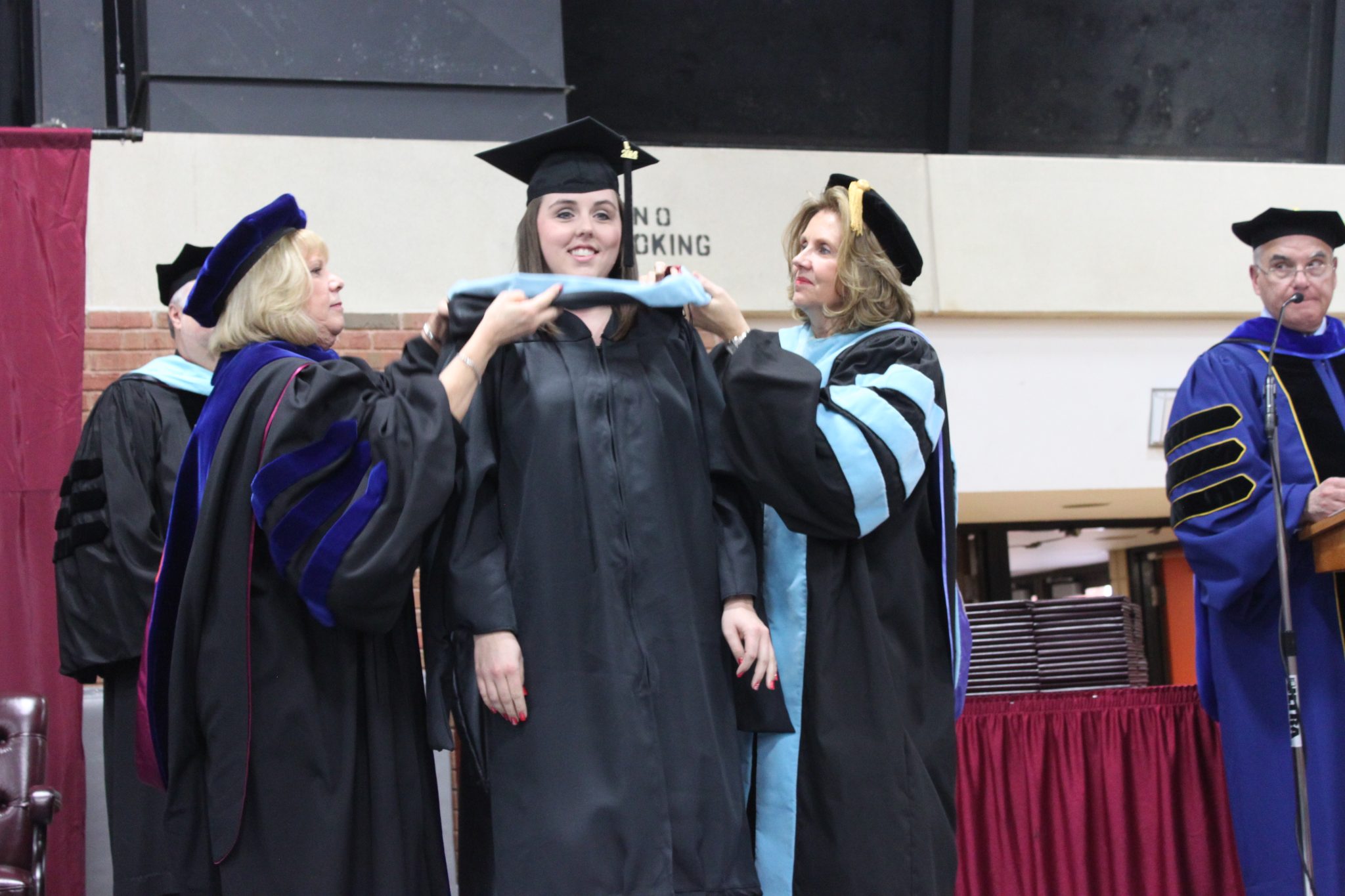 A Concord University graduate receiving her hood at commencement