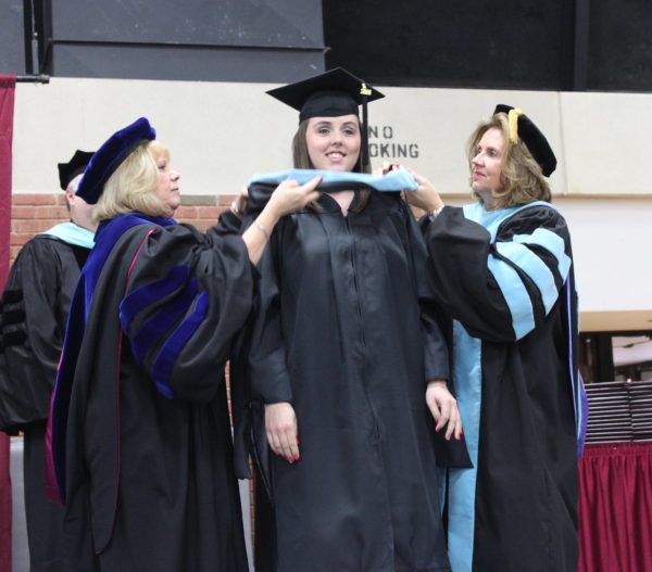 A Concord University graduate receiving her hood at commencement