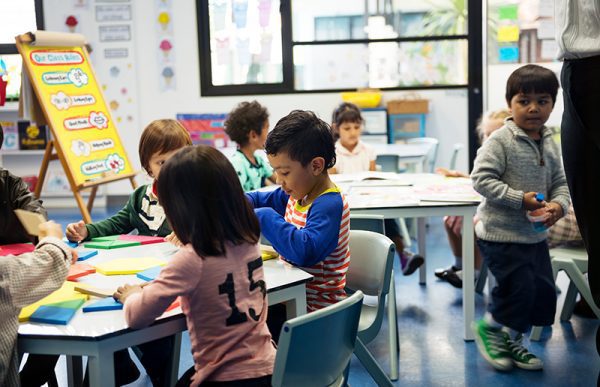 A group of kids playing and reading at daycare