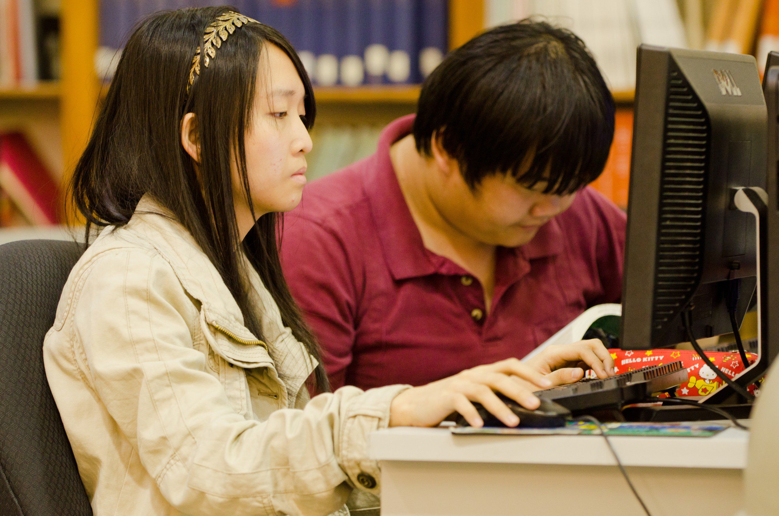 Two students working in the library