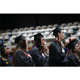 Students wearing their caps and gowns at commencement