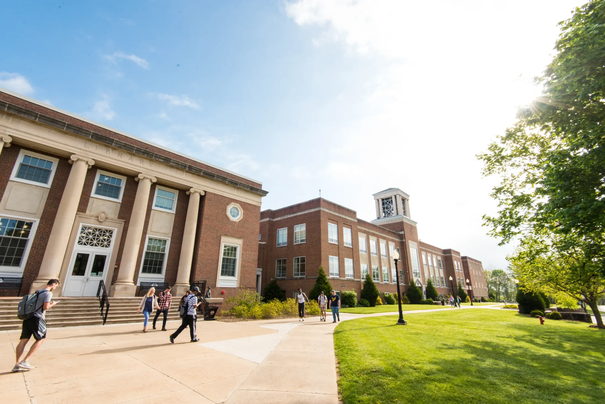 Concord University students walking around the Campus Beautiful on a sunny day