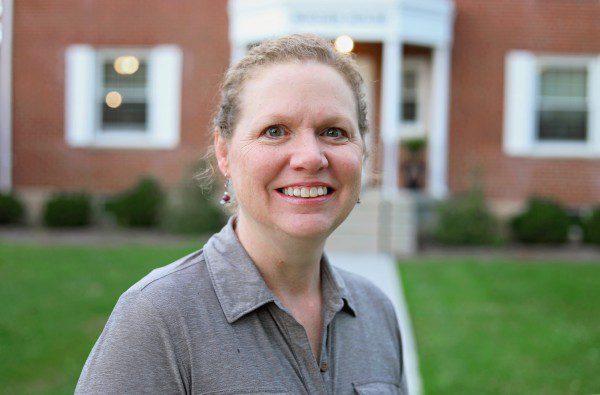 A photo of Kathy Ball standing in front of the Bonner House