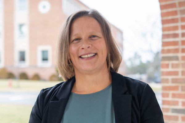 A photo of Lesley Ashford in front of the Science Building