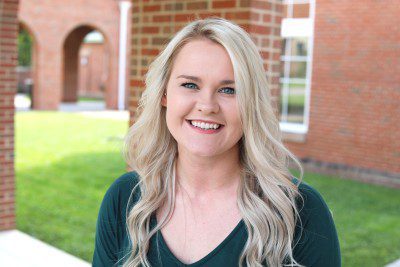 A photo of Dr. Samantha Byrd standing in front of University Point