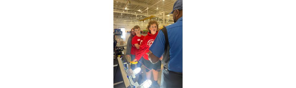 A group of students speaking to an electrical engineer