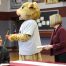 Concord University mascot Roar and President Boggess handing out dictionaries to Mercer County third grade students