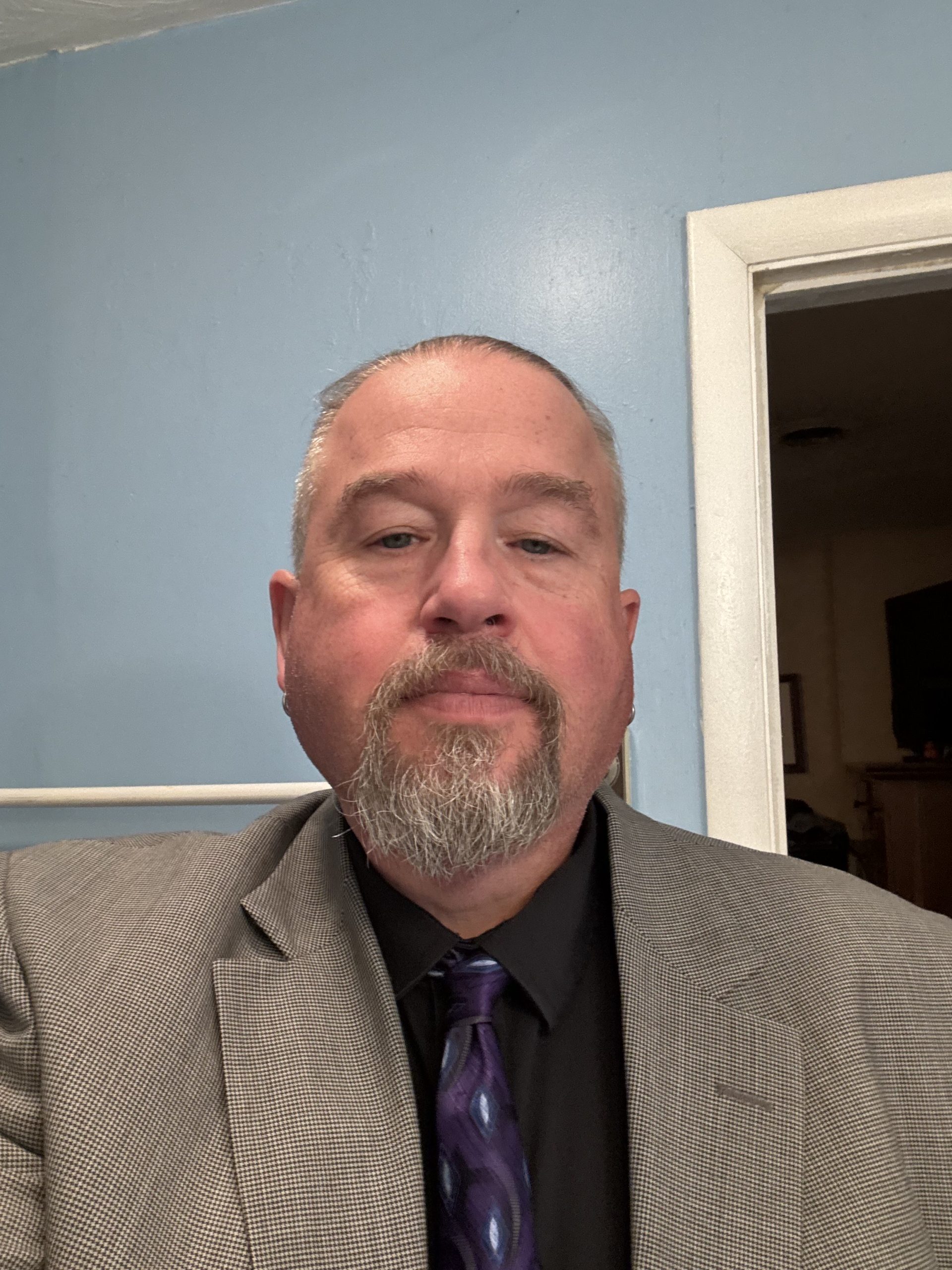 Bob Ballengee in front of a blue wall