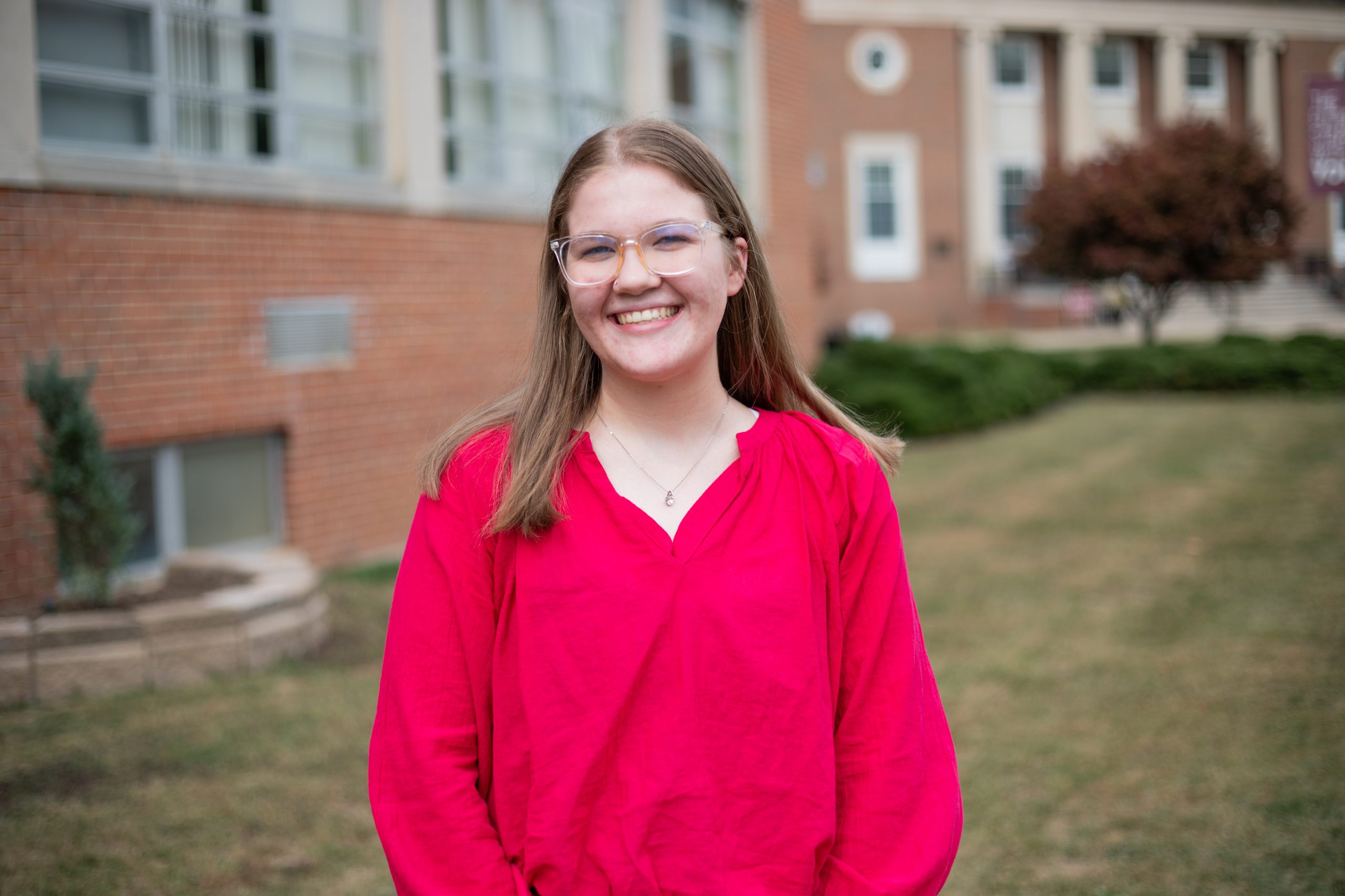 A photo of Secretary Lilly Palmer in front of the Beasley Student Center