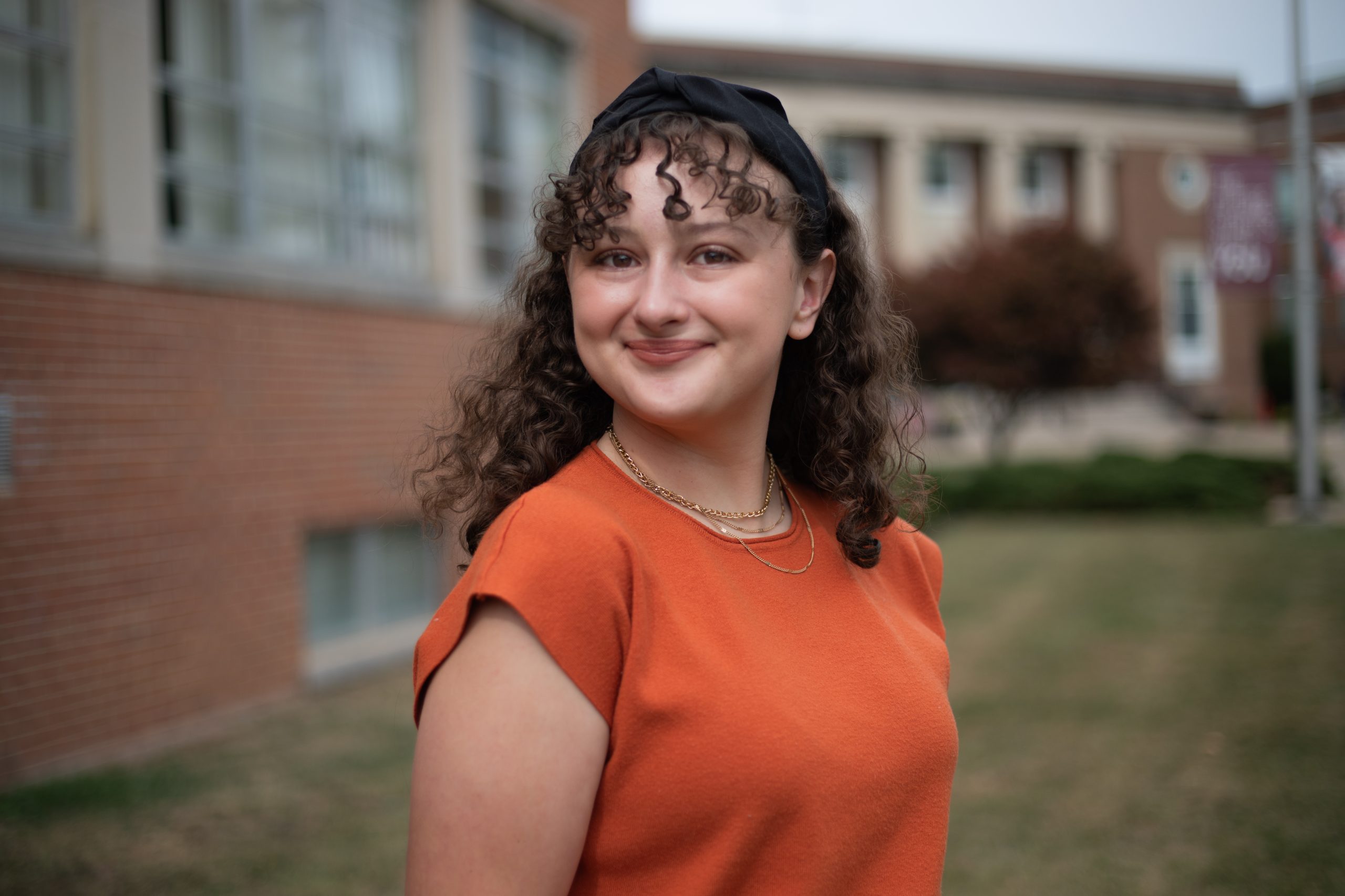 A photo of Faculty Executive Board Representative Mackenzie Franson in front of the Beasley Student Center