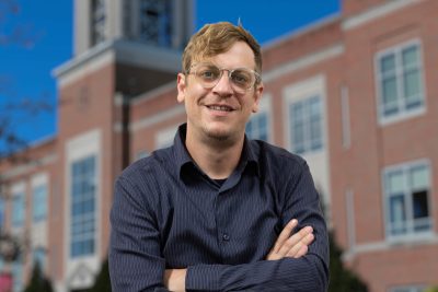 A photo of Jason Lockart in from of the Marsh Administration Building at Concord University