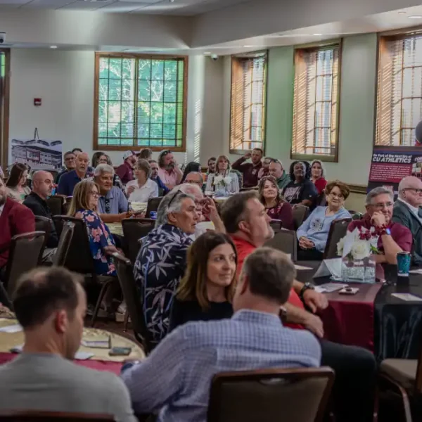Attendees of the knockout dinner listening to a speaker