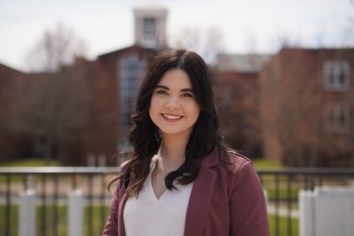 Madeline Hawkins in front of the Bell Tower