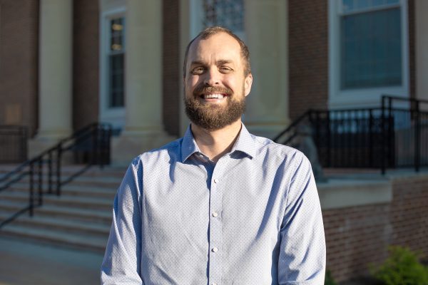 A photo of Mason Engelhardt standing in front of the J. Franklin Marsh Library at Concord University