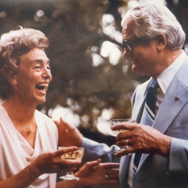 Woodlyn and Earl Kendrick laughing together while having drinks.
