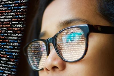A woman reading lines of code