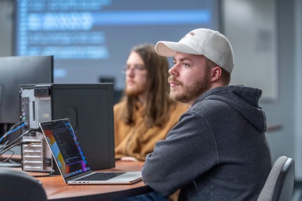 A photo of two computer science students working on an assignment in the computer science lab