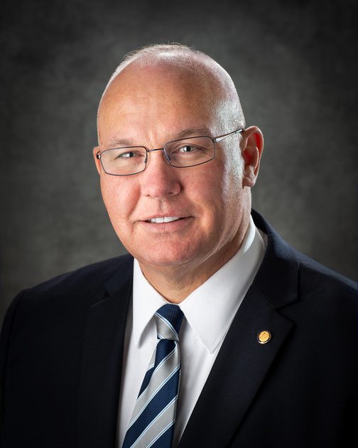 Jeff Campbell in front of a neutral background
