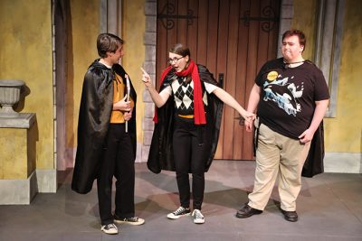 Three theatre students on stage performing the play Oh Harry.